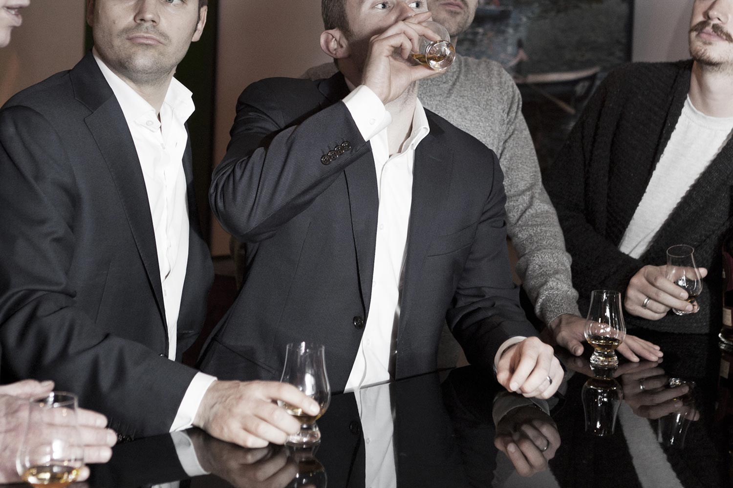 Men in suits drinking whisky