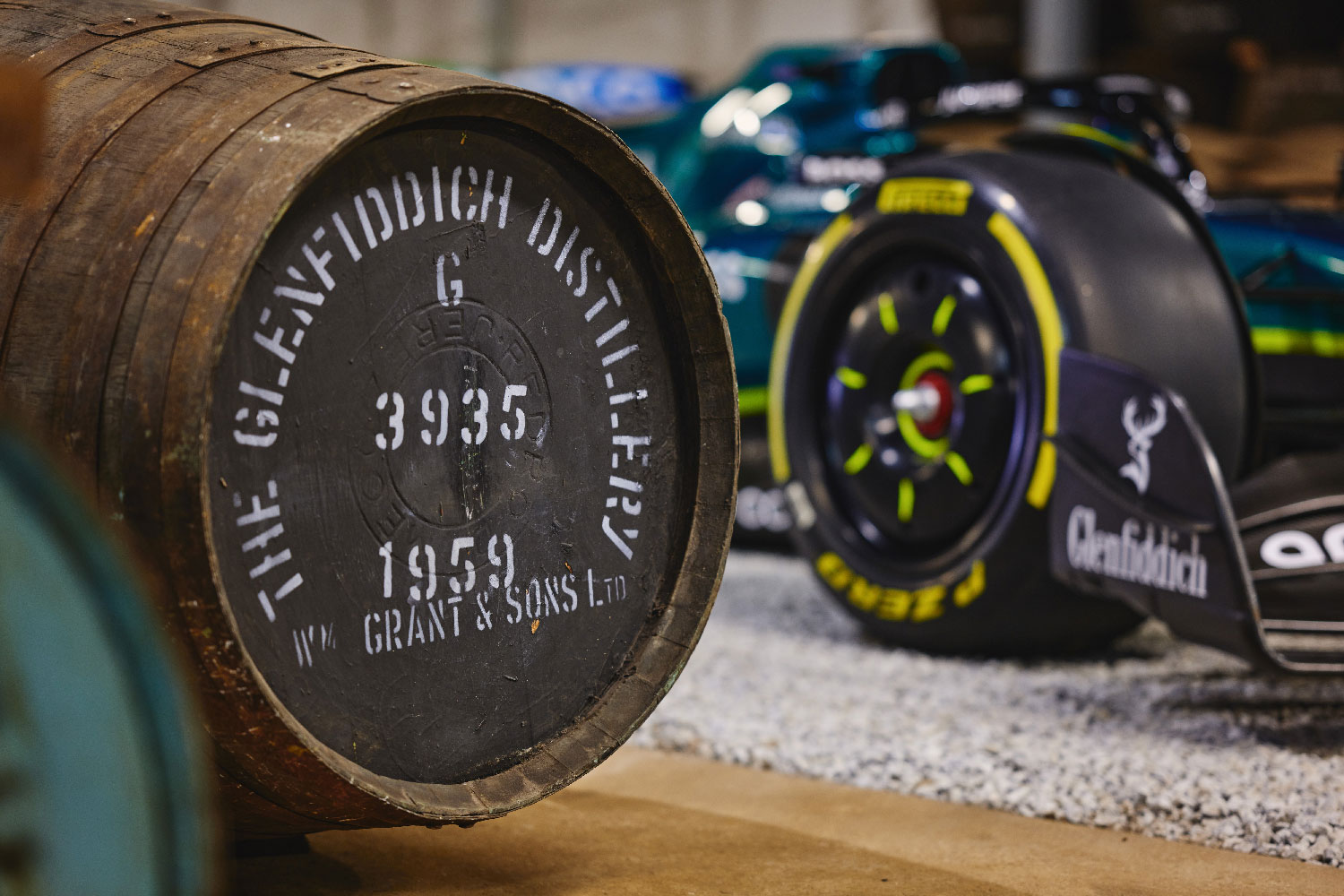 Formula one race car next to Glenfiddich barrel